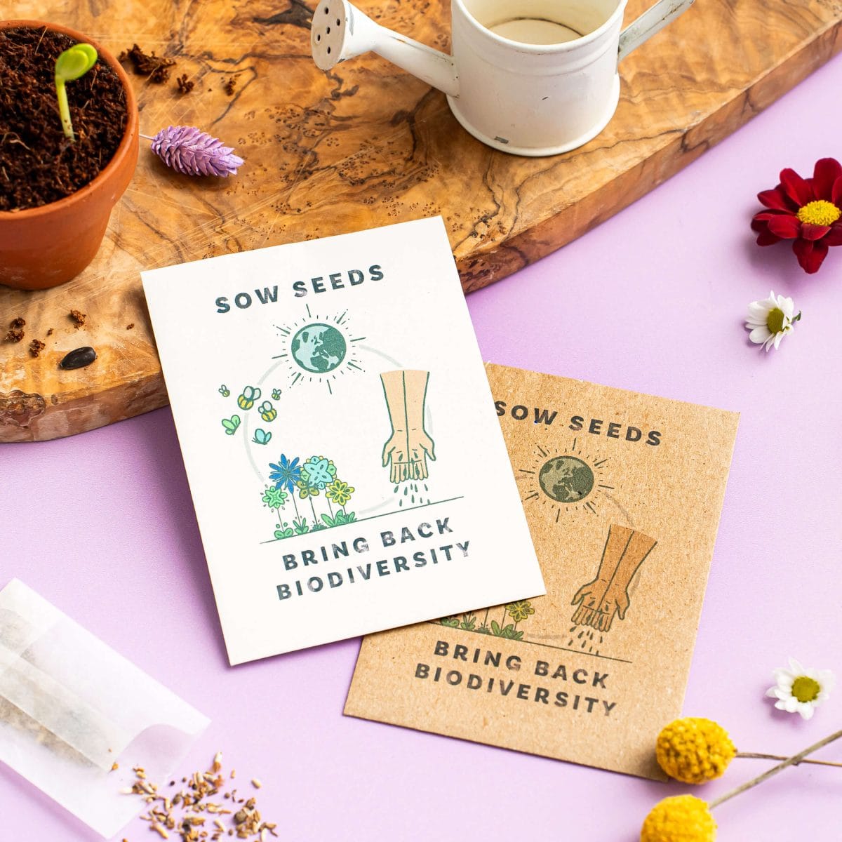 Wildflower seed cards with Bring Back Biodiversity message beside gardening accessories